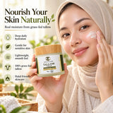 Woman applying NOVA TALLOW grass-fed beef tallow cream to her cheek while holding a 60g halal skincare jar.